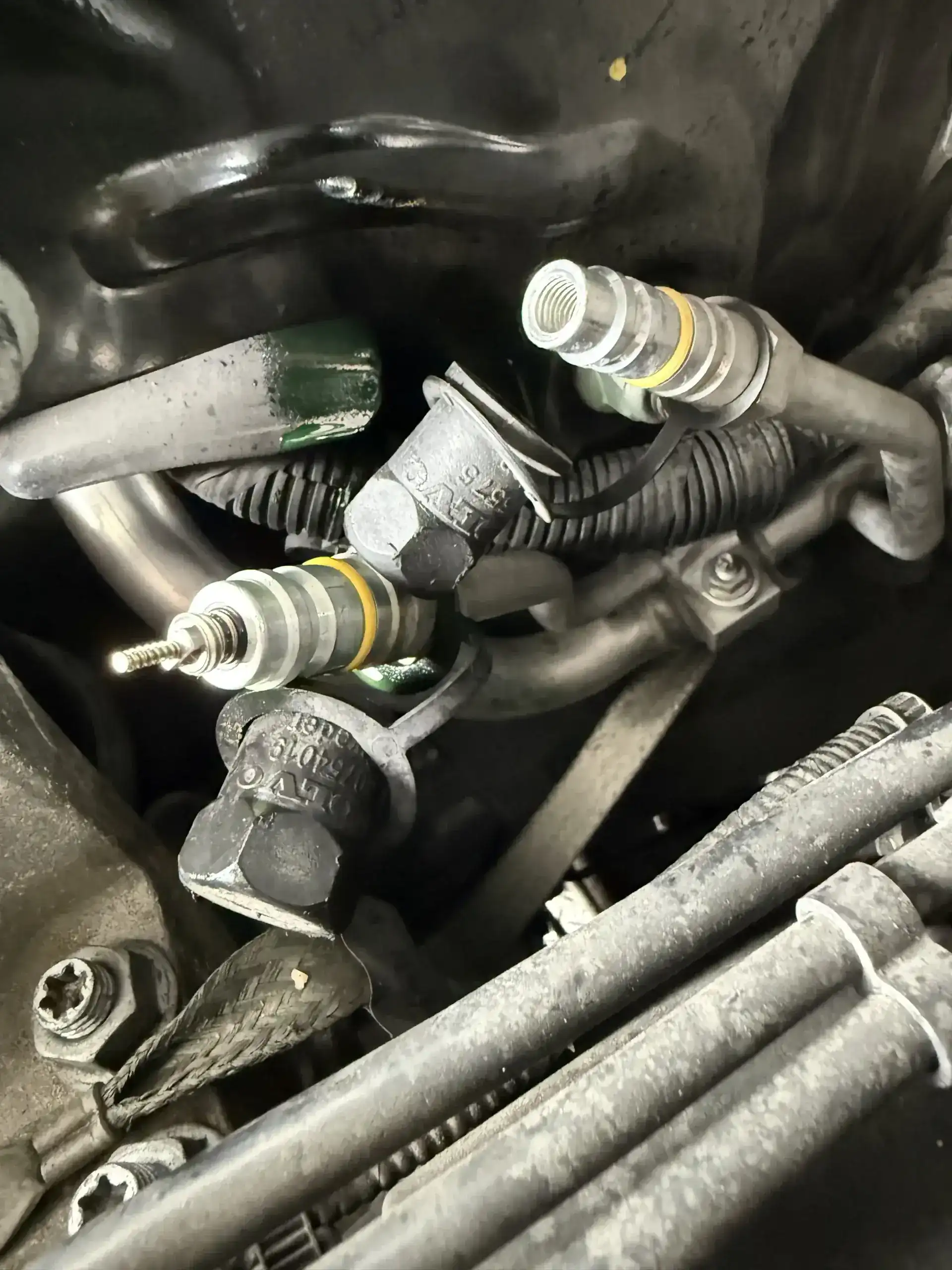 AC service port with valve core removed during leak detection at Beacon Auto Care San Mateo