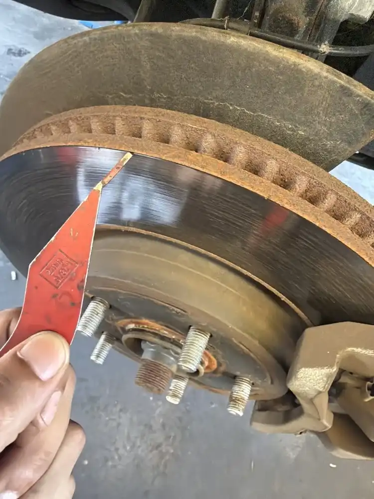 Front brake rotor inspection — diagnosing squealing brakes at Beacon Auto Care San Mateo