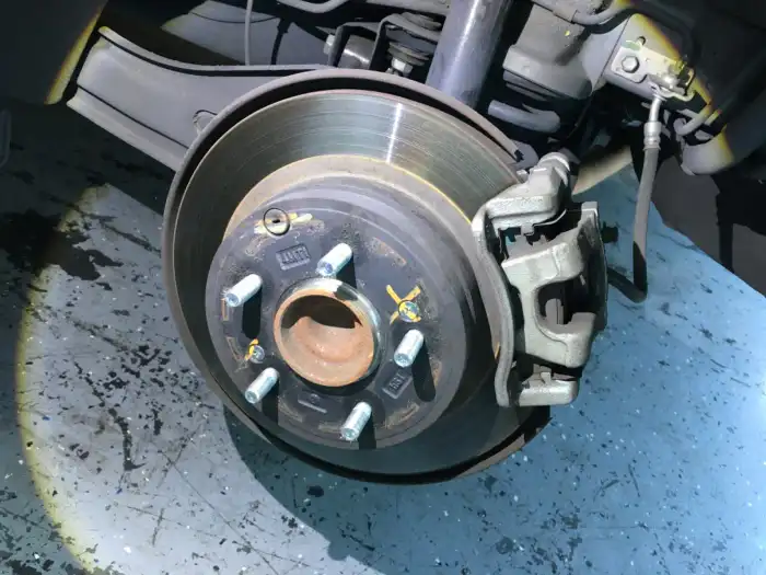 Rear brake rotor and caliper of a 2013 Hyundai Sonata during a San Mateo inspection — rear pads measured 6mm