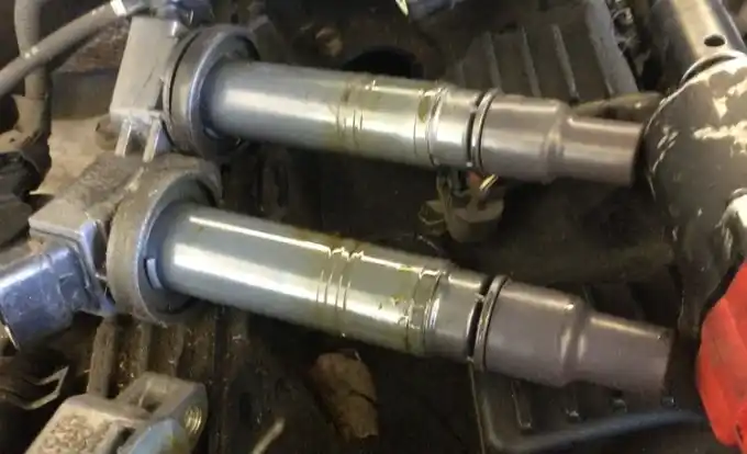 Worn, oil-fouled spark plugs pulled during a tune-up at Beacon Auto Care San Mateo